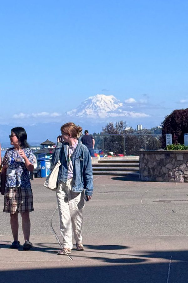 three women strolling and visiting along the waterfront on a sunny day